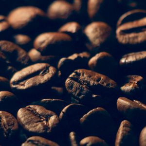 Detailed macro shot of roasted coffee beans showing rich texture.